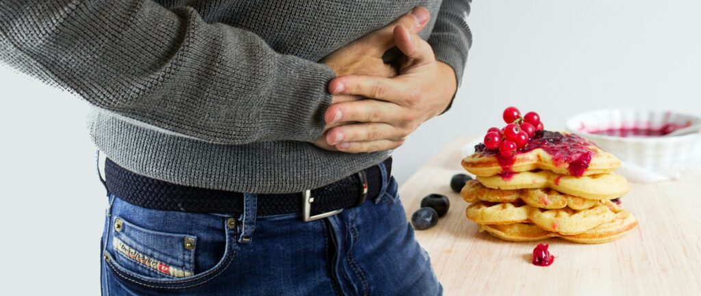 Man Having stomach aches after eating high-FODMAP foods