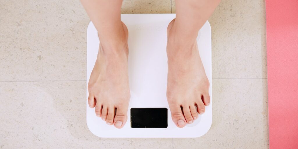 A person measuring their weight