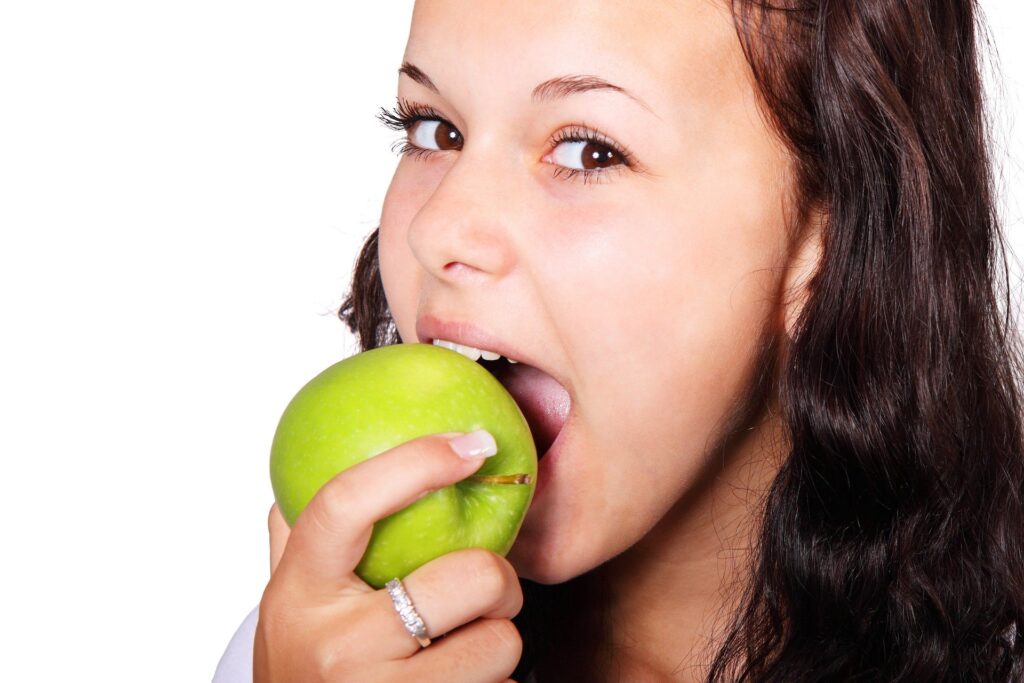 A girl that is on Mayo Clinic Diet eating apple