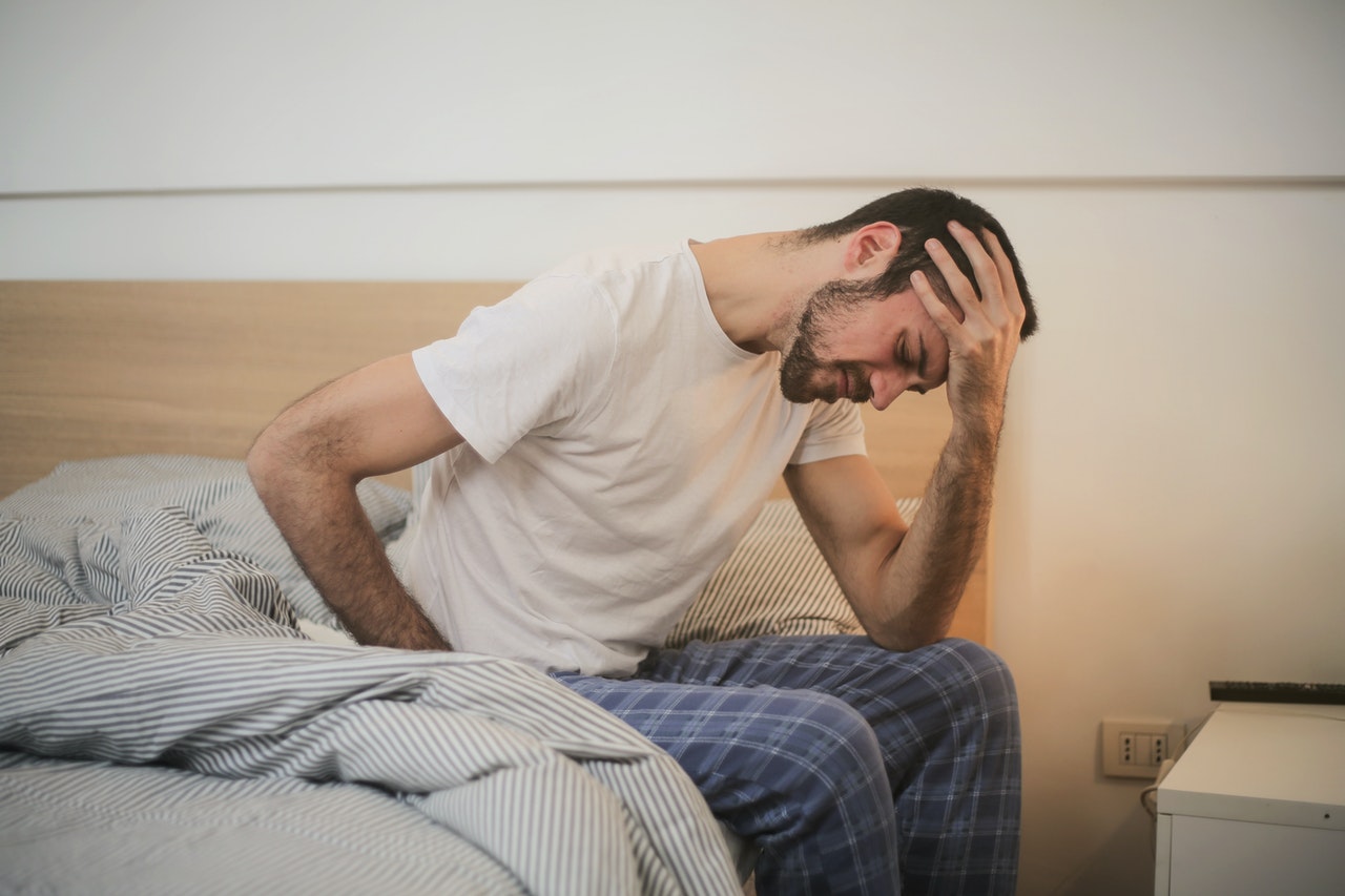 Young man with headache getting used to speed keto diet