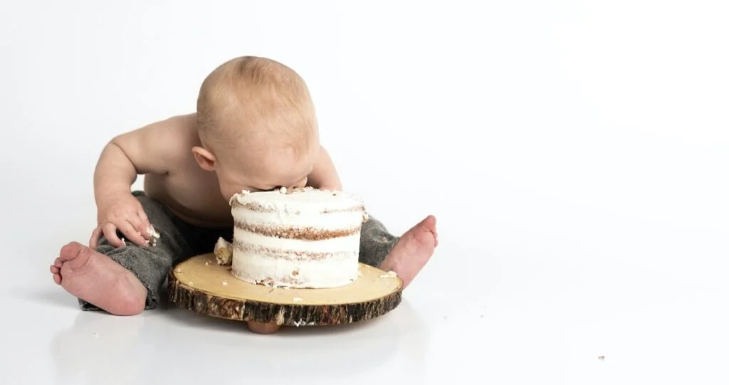 A baby eating a cake